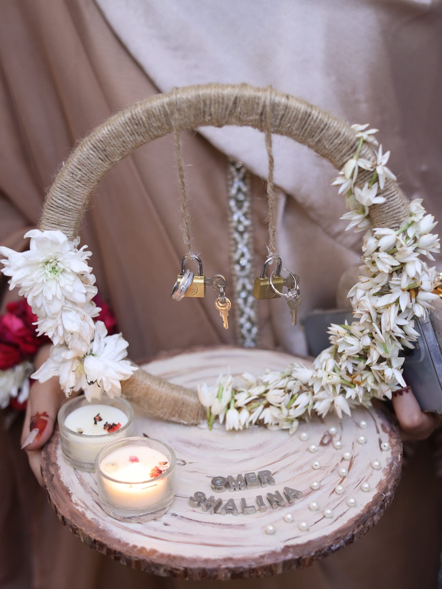 Ring tray with a jute hoop, jasmine flowers, padlocks, candles and pearls