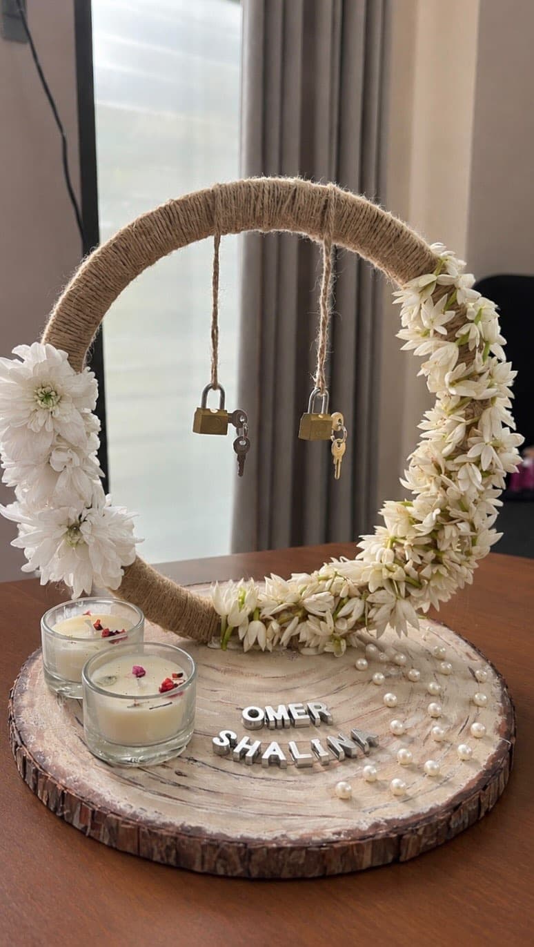 Jute hoop ring tray with hanging padlocks and keys above two candles