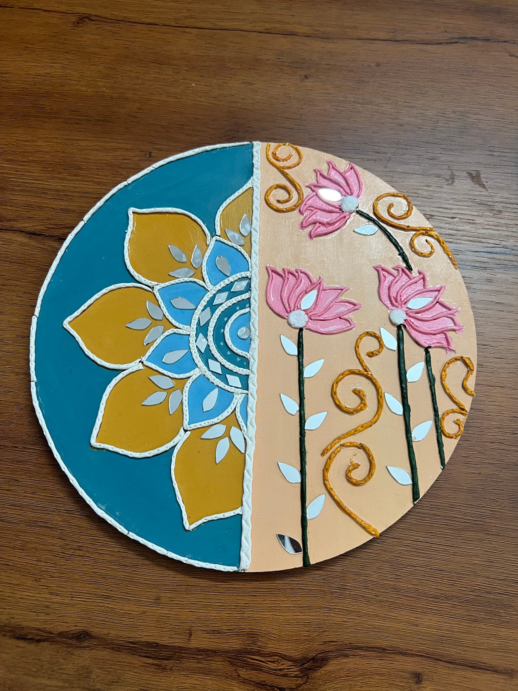 Round Lippan piece that is half teal mandala and half pink lotus on peach, with mirror accents